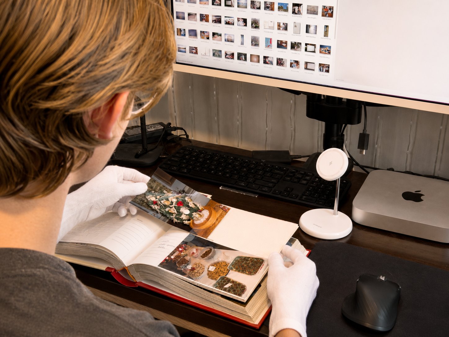 The archivist reviewing an album page at the scanning bench